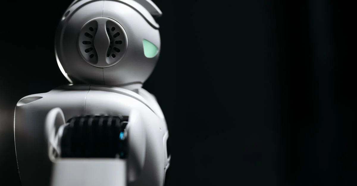 Gros plan d'un robot futuriste dans un studio sombre, mettant en avant l'innovation et la technologie.